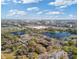 Aerial view of multi-unit dwellings near a lake, retail shopping, and neighborhood at 8825 Latrec Ave # 6308, Orlando, FL 32819