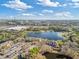Aerial view of multi-unit dwellings near a lake, retail shopping, and neighborhood at 8825 Latrec Ave # 6308, Orlando, FL 32819