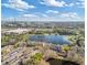 Aerial view of a multi-unit dwelling near a lake, retail shopping, and neighborhood at 8825 Latrec Ave # 6308, Orlando, FL 32819