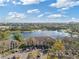 Aerial view of multi-unit dwelling near a small lake and neighborhood at 8825 Latrec Ave # 6308, Orlando, FL 32819