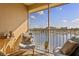 Relaxing balcony with comfortable seating and a picturesque lake view, creating a perfect outdoor retreat at 8825 Latrec Ave # 6308, Orlando, FL 32819