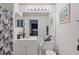 Bright bathroom with a decorative mirror, a vanity, and a shower and tub combo at 8825 Latrec Ave # 6308, Orlando, FL 32819