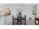 Dining room with seating for four, neutral colors, and view into the kitchen at 8825 Latrec Ave # 6308, Orlando, FL 32819