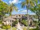Community clubhouse beautifully framed by tall palm trees and lush landscaping on a sunny day at 8825 Latrec Ave # 6308, Orlando, FL 32819