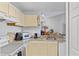 Bright and clean kitchen with essential appliances, a double sink, and plenty of room for culinary creations at 8825 Latrec Ave # 6308, Orlando, FL 32819