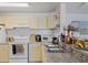 Functional kitchen featuring standard appliances, ample countertop space, and modern fixtures for everyday convenience at 8825 Latrec Ave # 6308, Orlando, FL 32819