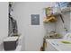Practical laundry room with washer, dryer, and storage shelves, providing efficient space for laundry tasks at 8825 Latrec Ave # 6308, Orlando, FL 32819