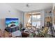 Inviting living room with ceiling fan, neutral colors, and sliding glass doors to the balcony with a waterfront view at 8825 Latrec Ave # 6308, Orlando, FL 32819