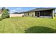 Expansive backyard showcasing well-maintained lawn and a screened patio area at 139 Sunfish Dr, Winter Haven, FL 33881