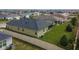 An overview of the backyard, highlighting a green lawn and a screened-in porch at 139 Sunfish Dr, Winter Haven, FL 33881