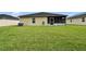 Spacious backyard featuring a screened-in porch and lush green lawn at 139 Sunfish Dr, Winter Haven, FL 33881