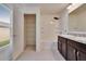 Bright bathroom featuring a double sink vanity, tub with shower, and a walk-in closet with ample shelving at 139 Sunfish Dr, Winter Haven, FL 33881