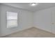 Bright bedroom with neutral carpet, a window with blinds, and a ceiling light at 139 Sunfish Dr, Winter Haven, FL 33881