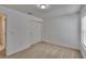 Neutral bedroom featuring a closet with sliding doors, neutral carpet and a window at 139 Sunfish Dr, Winter Haven, FL 33881