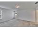 A simple bedroom features neutral walls, carpet, a ceiling light, and a pair of windows at 139 Sunfish Dr, Winter Haven, FL 33881