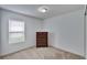 A cozy bedroom features a window with blinds and a wooden chest of drawers at 139 Sunfish Dr, Winter Haven, FL 33881