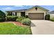 Charming single-story home featuring a well-manicured lawn and a two-car garage at 139 Sunfish Dr, Winter Haven, FL 33881