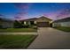 Inviting single-story home with a lush green lawn, a wide driveway, and an attached garage at 139 Sunfish Dr, Winter Haven, FL 33881