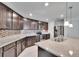 Modern kitchen featuring stainless steel appliances, dark cabinetry, and granite countertops at 139 Sunfish Dr, Winter Haven, FL 33881