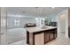 Open kitchen island with stainless steel dishwasher and sink that overlooks the living room at 139 Sunfish Dr, Winter Haven, FL 33881