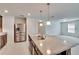 Open concept kitchen with stainless steel refrigerator and island with double sink at 139 Sunfish Dr, Winter Haven, FL 33881