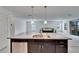 Kitchen island with stainless steel sink overlooking the living room area at 139 Sunfish Dr, Winter Haven, FL 33881