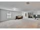 Bright living room featuring plush carpeting, ample windows, and a sliding glass door to the backyard at 139 Sunfish Dr, Winter Haven, FL 33881