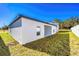 Backyard with green grass and partial view of the house at 13434 Leaping Water Way, Astatula, FL 34705