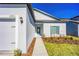 View of the front of the home displaying a walkway, mulch beds, and white exterior paint at 13434 Leaping Water Way, Astatula, FL 34705