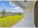 Back patio view of the spacious lawn and fence at 276 Woodsage Pl, Lake Alfred, FL 33850