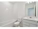 Clean bathroom featuring subway tile, a modern vanity, and a shower-tub combination at 276 Woodsage Pl, Lake Alfred, FL 33850