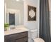 Stylish bathroom featuring a modern vanity, toilet, shower-tub combo, and decorative accents at 276 Woodsage Pl, Lake Alfred, FL 33850