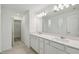 Modern bathroom with dual sinks, white cabinets, quartz countertops, and tile floors at 276 Woodsage Pl, Lake Alfred, FL 33850