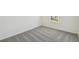Bedroom with neutral carpet, white walls and baseboards, with window view at 276 Woodsage Pl, Lake Alfred, FL 33850