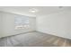 Empty bedroom with neutral walls, plush carpeting, and a large window, ready for personalization at 276 Woodsage Pl, Lake Alfred, FL 33850