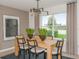 Dining room features a modern chandelier, seating for six, and a large window with lake views at 276 Woodsage Pl, Lake Alfred, FL 33850