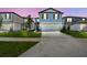 Exterior of the home with a well-manicured lawn, driveway, and charming curb appeal at 276 Woodsage Pl, Lake Alfred, FL 33850