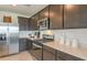 Modern kitchen featuring stainless steel appliances, dark wood cabinets and light countertops at 276 Woodsage Pl, Lake Alfred, FL 33850