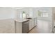 Spacious kitchen island with stainless steel dishwasher, sleek countertops, and ample cabinet space for storage at 276 Woodsage Pl, Lake Alfred, FL 33850