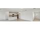 Open-concept kitchen featuring white cabinets, stainless steel appliances, and a breakfast bar island at 276 Woodsage Pl, Lake Alfred, FL 33850