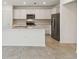 Modern kitchen with white cabinets, stainless steel appliances, and a spacious island at 276 Woodsage Pl, Lake Alfred, FL 33850