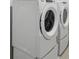 Laundry room showcasing the new, front-load washer and dryer at 276 Woodsage Pl, Lake Alfred, FL 33850