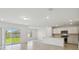 Bright open-concept living area connects kitchen, living, and dining areas at 276 Woodsage Pl, Lake Alfred, FL 33850