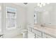 Bright bathroom with white vanity, modern fixtures, and subway tiled shower/tub combo at 284 Woodsage Pl, Lake Alfred, FL 33850