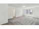 Spacious bedroom with plush carpeting, natural light, and an adjoining door at 284 Woodsage Pl, Lake Alfred, FL 33850