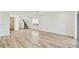 Unfurnished living room boasting wood flooring, a staircase, and access to an outdoor patio at 284 Woodsage Pl, Lake Alfred, FL 33850