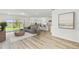 Bright, open-concept living room featuring modern flooring, neutral decor, and seamless access to the outdoor space at 284 Woodsage Pl, Lake Alfred, FL 33850