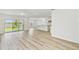 Open living area featuring sliding glass doors to the backyard and kitchen access with center island at 284 Woodsage Pl, Lake Alfred, FL 33850