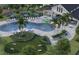 Aerial view of a palm-lined pool and lounge area with playground at 284 Woodsage Pl, Lake Alfred, FL 33850