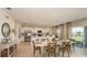 Spacious dining area adjacent to a modern kitchen with stainless steel appliances and center island at 4635 Snapdragon Pl, Lake Hamilton, FL 33851